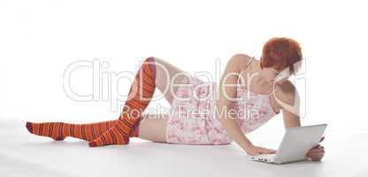 Red Girl in stripe socks  with laptop on white background