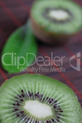The cut fruit kiwi on a bamboo napkin