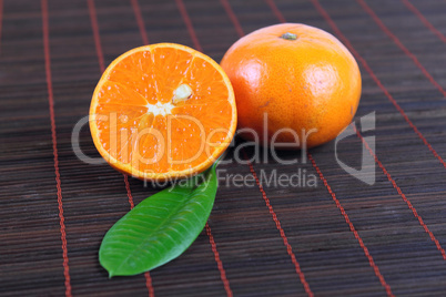 Two tangerines on a bamboo napkin