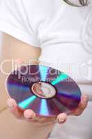 Compact disc in hands of the girl