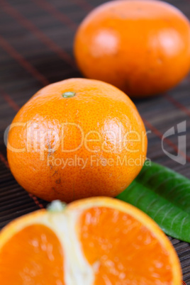 Three tangerines on a bamboo napkin