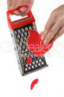 Female hands rubbing heart on a kitchen grater