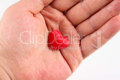 Red silk heart on a man's palm