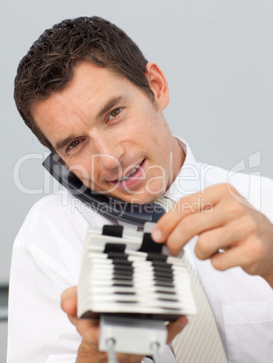 Attractive businessman on phone holding a card holder