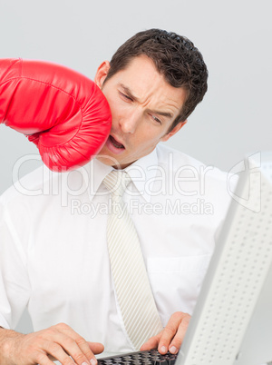 A businessman being boxed in his face