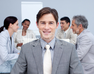 Close-up of a smiling young businessman in a meeting