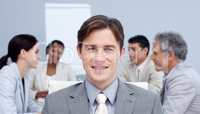 Portrait of an attractive busienssman smiling in a meeting