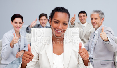 Happy business team celebrating a sucess with thumbs up
