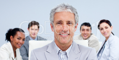 Portrait of a mature businessman smiling in a meeting