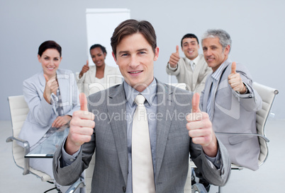 Attractive businessman celebrating a sucess with his team