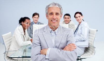 Mature businessman smiling in a meeting