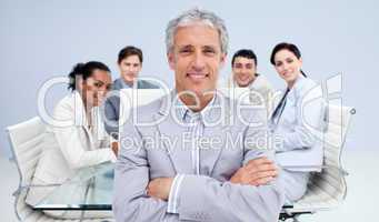 Mature businessman smiling in a meeting