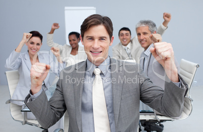 Happy business team celebrating a sucess with hands up