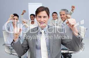 Happy business team celebrating a sucess with hands up