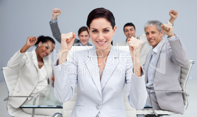 Happy business people celebrating a sucess with hands up