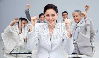 Happy business people celebrating a sucess with hands up