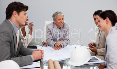 Architects in a meeting studying plans