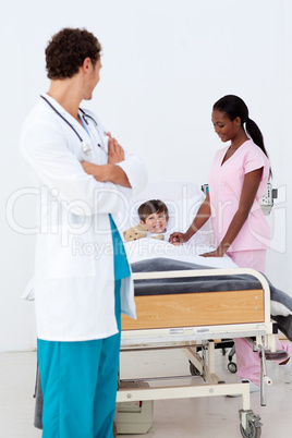 Pediatrician and nurse attending to a child in the hospital