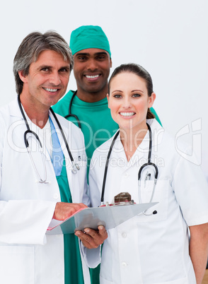 Smiling doctors and surgeon taking notes