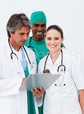 Smiling female doctor taking notes with her colleagues