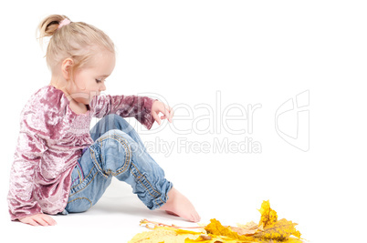 Toddler with maple leaves