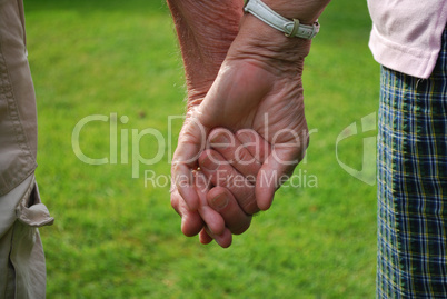 senior couple holding hands