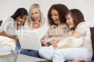 Four Interracial Female Friends Laughing and Looking at Laptop C