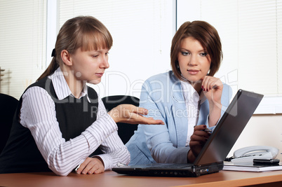 Two young woman in office