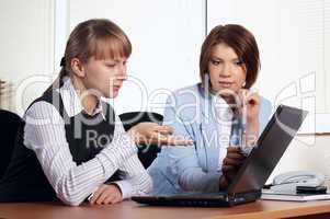 Two young woman in office