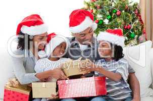 Afro-American family holding Christmas gifts