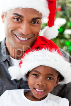 Portrait of a smiling father and daughter at Christmas time