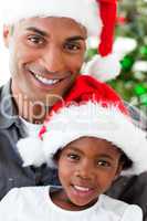 Portrait of a smiling father and daughter at Christmas time