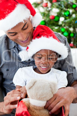 Happy father and daughter playing with Christmas gifts