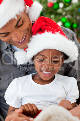 Portrait of an Afro-American father and daughter playing with Ch