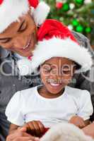 Portrait of an Afro-American father and daughter playing with Ch