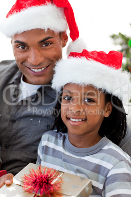 Portrait of an Afro-American father and son holding a Christmas
