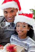 Portrait of an Afro-American father and son holding a Christmas