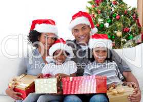 Afro-American family holding Christmas presents