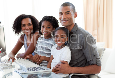 Happy Afro-American family working with a computer at home