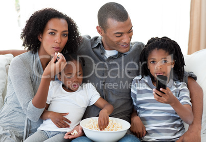 Afro-American family watching a film at home