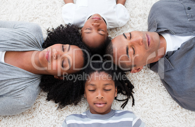 Afro-American young family lying on floor