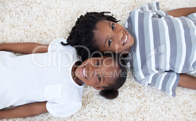 Brother and sister on floor with heads together