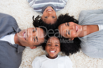 Afro-American family on floor with heads together