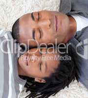 Portrait of Afro-American father and son sleeping on the floor
