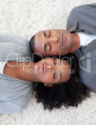 Afro-American couple sleeping on the floor