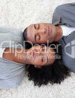 Afro-American couple sleeping on the floor