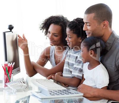 Afro-American family working with a computer at home