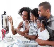 Afro-American family working with a computer at home