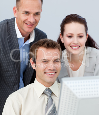 Portrait of business people working together with a computer