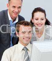 Portrait of business people working together with a computer